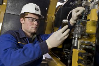 Cat technician taking an oil sample