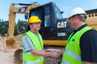 Two man in construction vests shaking hands