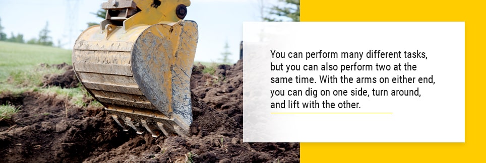 Close up image of a backhoe loader arm digging up earth